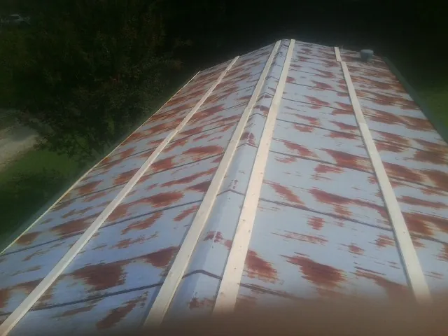 Rusted metal roof panels with new wood purlins before replacement — Storm Damage Roof Repair in Fountain by Roofing Brothers